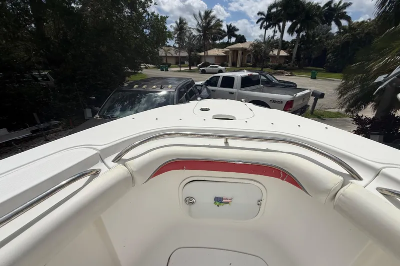 Slide: The Image of 2001 Wellcraft 29 Scarab Sport Open boat, parked in a residential driveway with palm trees. - 89