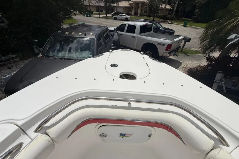 Slide: The Image of 2001 Wellcraft 29 Scarab Sport Open boat parked near trucks in residential area. - 90