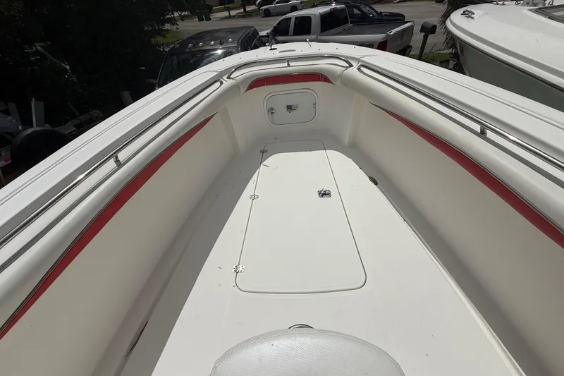 Slide: The Image of 2001 Wellcraft 29 Scarab Sport Open boat deck with red accents and storage compartment. - 94