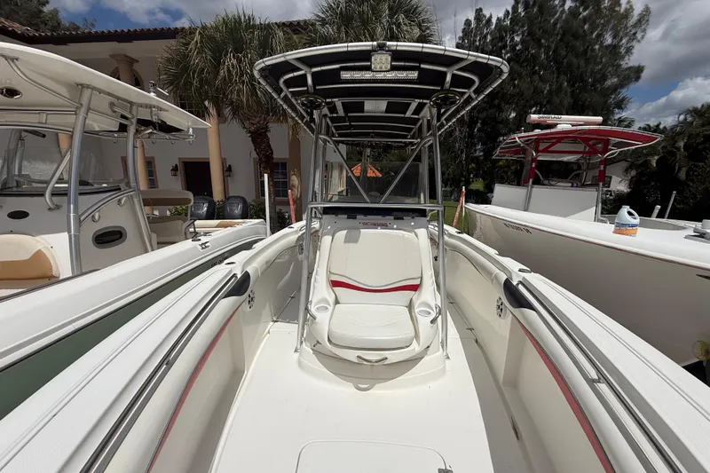 Slide: The Image of 2001 Wellcraft 29 Scarab Sport Open boat with sleek white interior and red accents. - 99