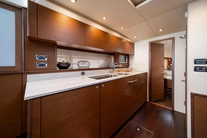 Slide: The Image of Luxurious kitchen interior of 2013 Sea Ray Sundancer 540 yacht with modern wood cabinetry. - 12