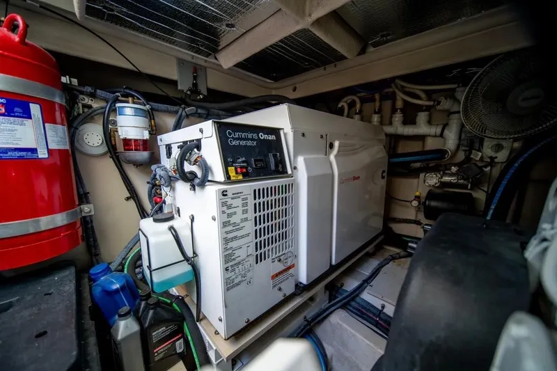 Slide: The Image of Engine room of 2013 Sea Ray Sundancer 540 with Cummins Onan generator and safety equipment. - 26