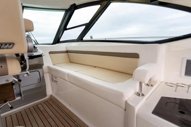 Slide: The Image of Interior of 2013 Sea Ray Sundancer 540 yacht with beige seating and wooden flooring. - 36