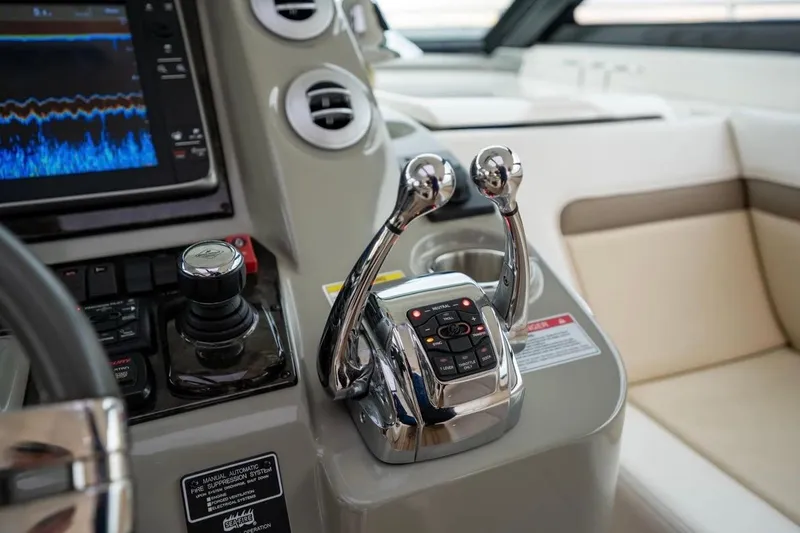 Slide: The Image of Control panel of a 2013 Sea Ray Sundancer 540 yacht with dual throttle levers. - 38