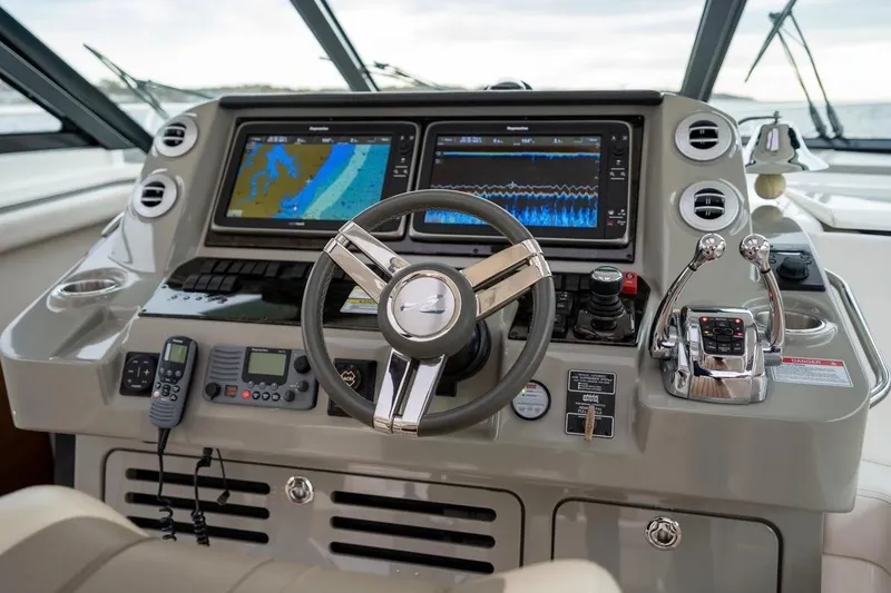 Slide: The Image of Helm of 2013 Sea Ray Sundancer 540 with navigation screens and controls. - 39