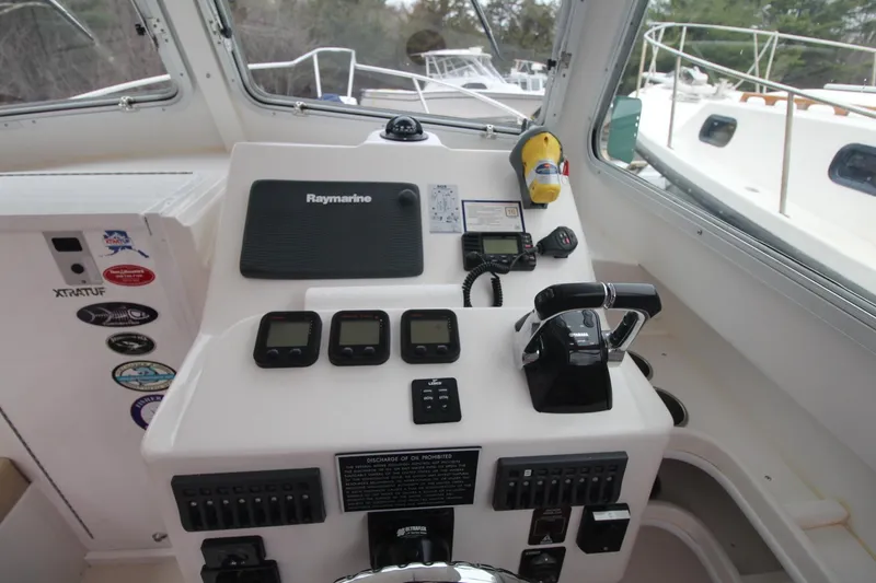 Slide: The Image of Steiger Craft 26 Miami 2014 boat dashboard with Raymarine electronics and control panel. - 13
