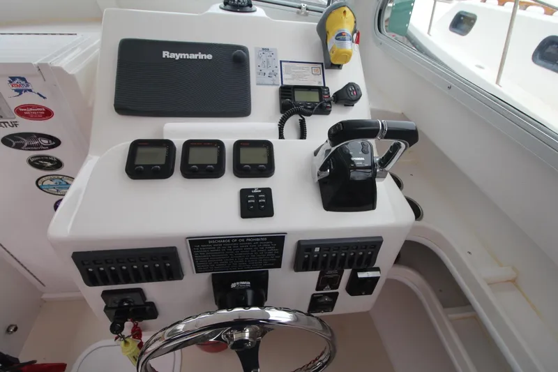Slide: The Image of 2014 Steiger Craft 26 Miami helm with Raymarine electronics and Yamaha controls. - 14