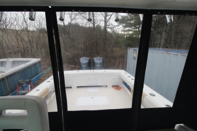 Slide: The Image of 2014 Steiger Craft 26 Miami boat interior view with twin engines and outdoor setting. - 15