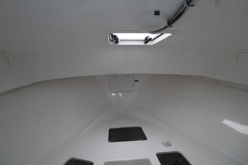 Slide: The Image of Interior cabin of 2014 Steiger Craft 26 Miami boat, featuring a hatch and storage compartments. - 17