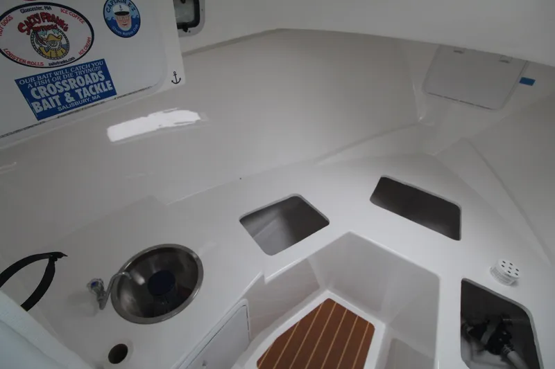 Slide: The Image of 2014 Steiger Craft 26 Miami boat interior with sink and storage compartments. - 18