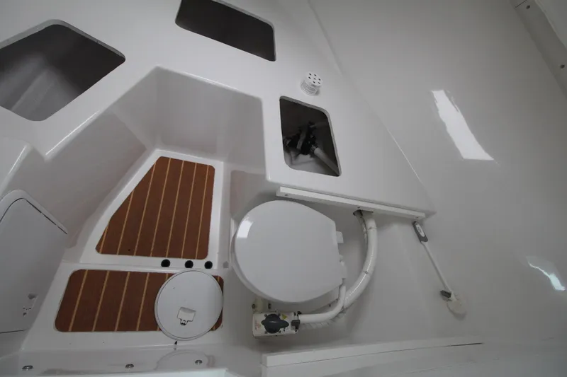 Slide: The Image of 2014 Steiger Craft 26 Miami boat interior with toilet and wooden flooring. - 19