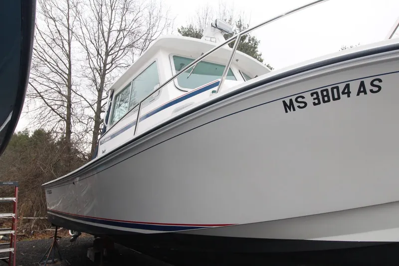 Slide: The Image of 2014 Steiger Craft 26 Miami boat on land, with registration MS 3804 AS. - 2