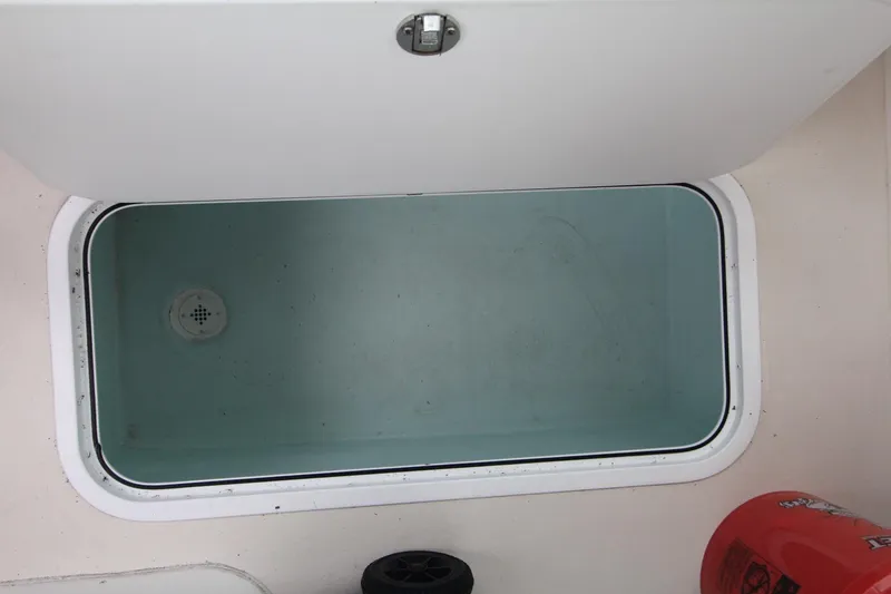 Slide: The Image of Open storage compartment on 2014 Steiger Craft 26 Miami boat. - 21