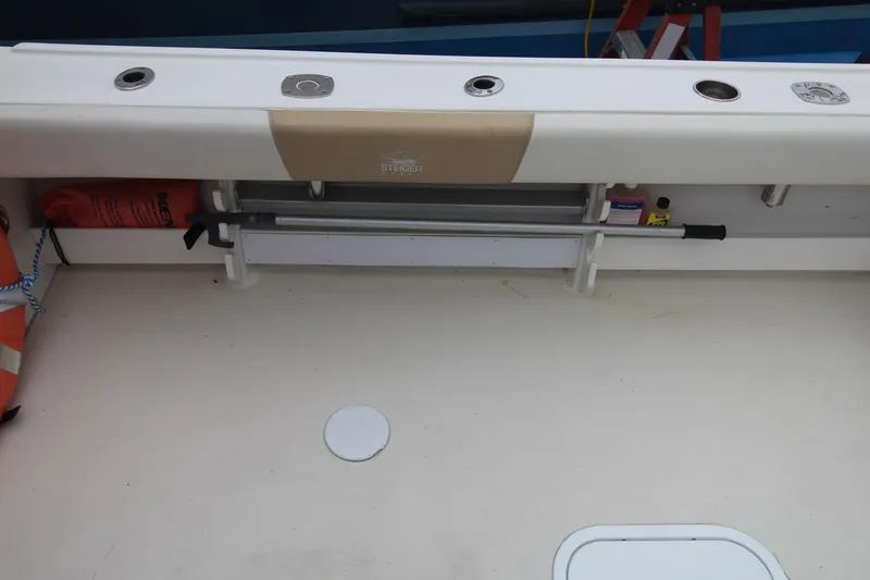 Slide: The Image of 2014 Steiger Craft 26 Miami boat deck with storage compartments and safety equipment. - 22