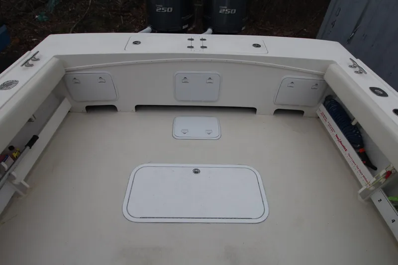 Slide: The Image of 2014 Steiger Craft 26 Miami boat deck with storage compartments and Yamaha engines. - 24