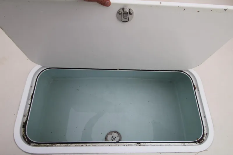 Slide: The Image of Open storage compartment on 2014 Steiger Craft 26 Miami boat. - 25