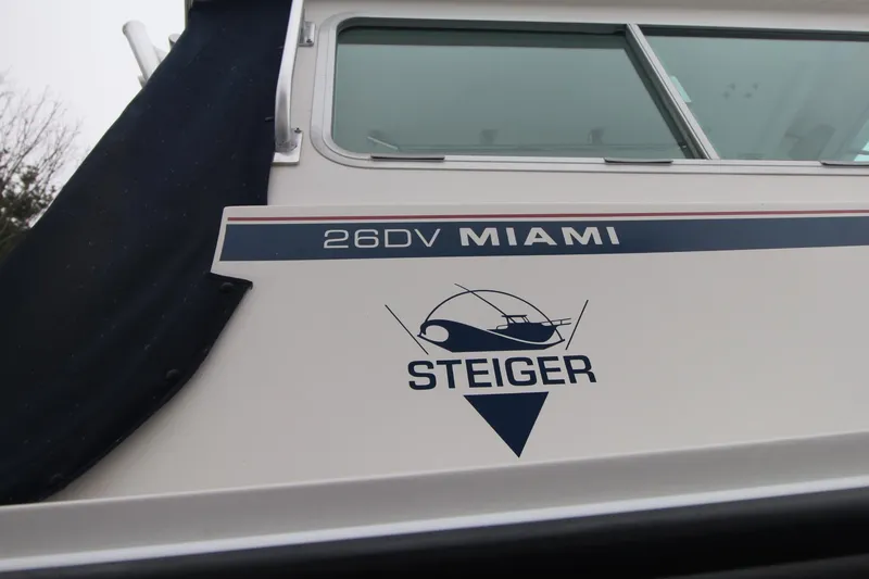 Slide: The Image of 2014 Steiger Craft 26 Miami boat side view with logo and window. - 3