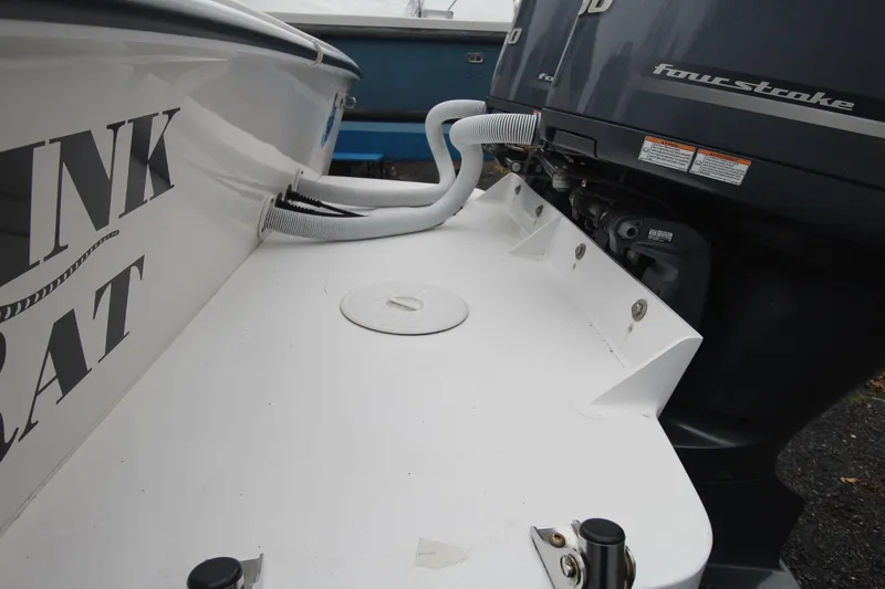 Slide: The Image of 2014 Steiger Craft 26 Miami boat with outboard motor and deck details. - 4