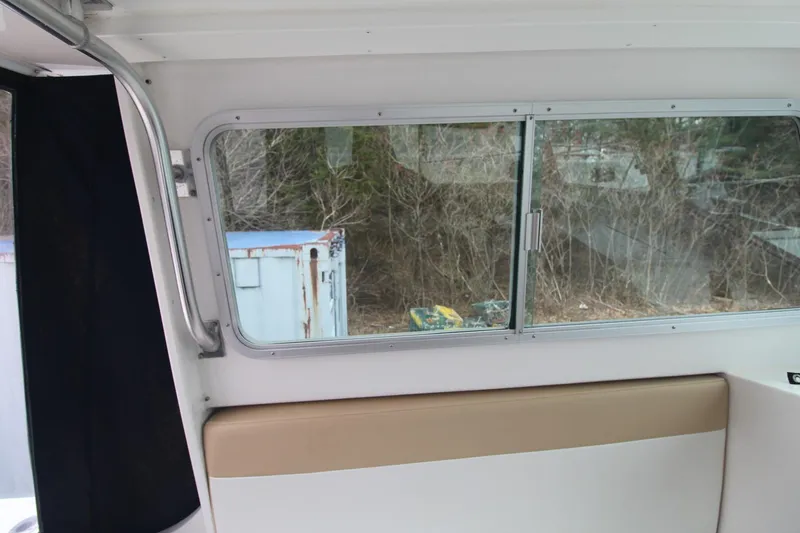 Slide: The Image of Interior view of 2014 Steiger Craft 26 Miami boat with window and seating. - 8
