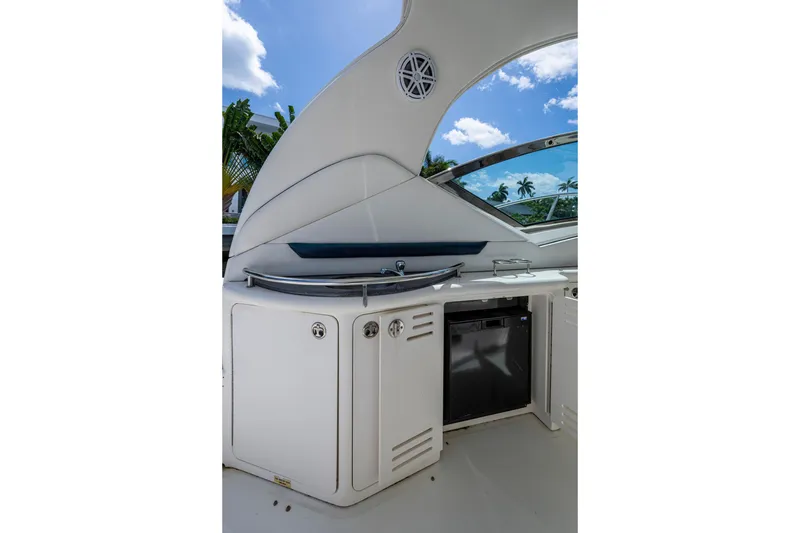 Slide: The Image of 2005 Sea Ray 420 Sundancer yacht interior with kitchenette under blue sky. - 10