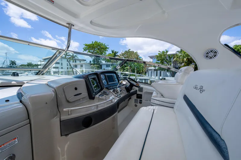 Slide: The Image of 2005 Sea Ray 420 Sundancer cockpit with modern controls and luxurious seating. - 12