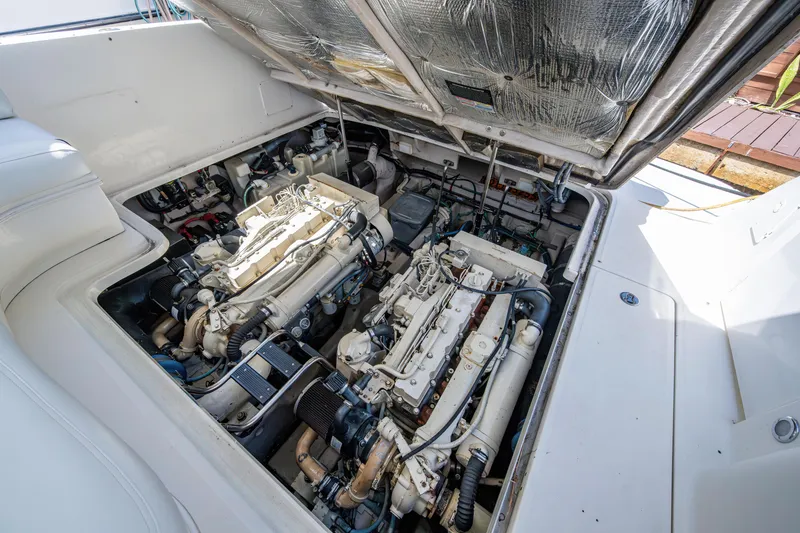 Slide: The Image of Engine compartment of a 2005 Sea Ray 420 Sundancer yacht, showcasing dual engines. - 13