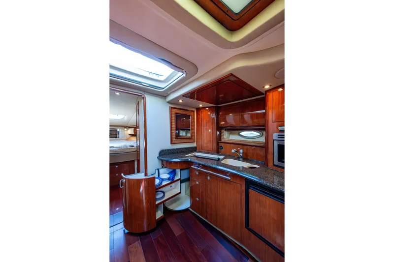 Slide: The Image of Luxurious 2005 Sea Ray 420 Sundancer yacht interior with elegant wood cabinetry and modern amenities. - 15