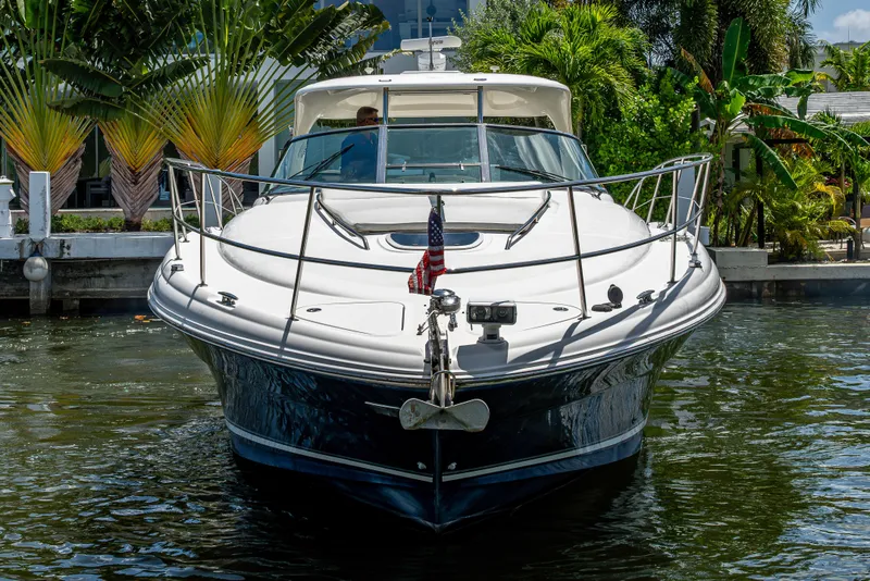 Slide: The Image of 2005 Sea Ray 420 Sundancer yacht docked, surrounded by lush tropical greenery. - 2