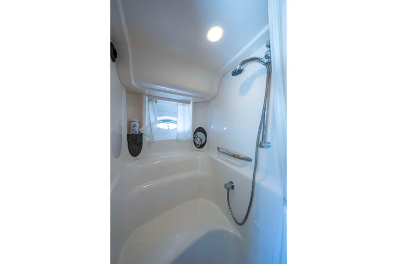 Slide: The Image of Luxurious bathroom interior of 2005 Sea Ray 420 Sundancer yacht with shower and window. - 21