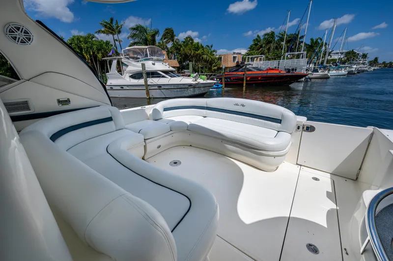 Slide: The Image of Luxurious 2005 Sea Ray 420 Sundancer yacht with spacious white seating, docked in a scenic marina. - 7