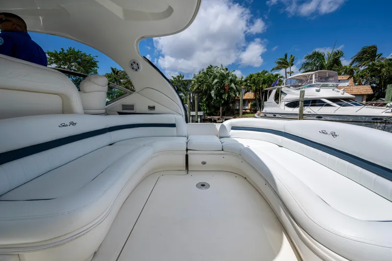 Slide: The Image of Luxurious 2005 Sea Ray 420 Sundancer yacht interior with white seating and blue accents. - 8