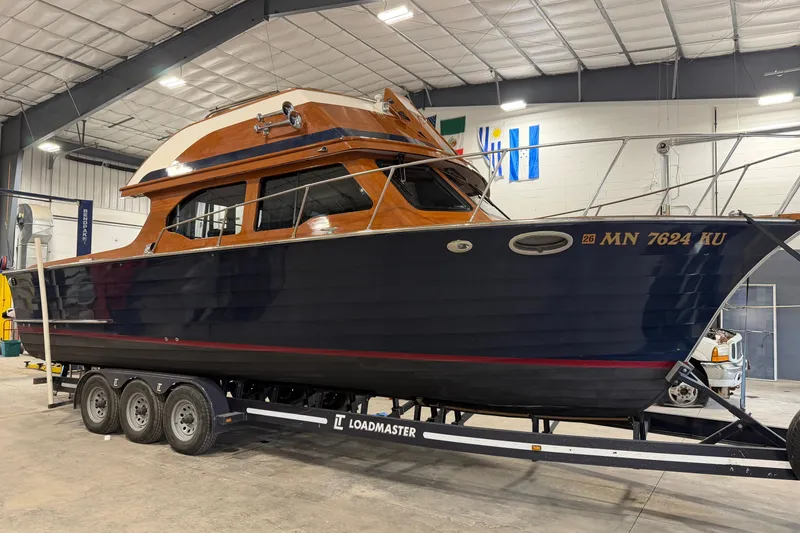 The Image of 1986 Skiff Craft X-31 Sportsman Custom boat on trailer in indoor storage facility. - 0