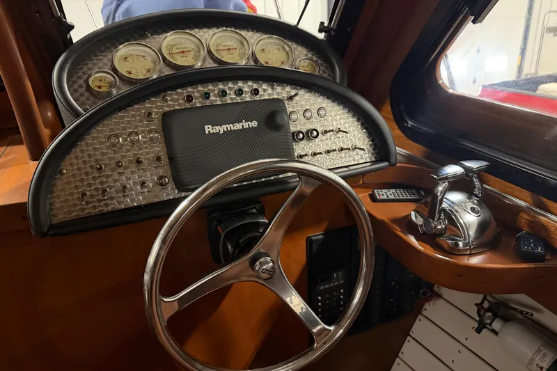 Slide: The Image of 1986 Skiff Craft X-31 Sportsman Custom dashboard with Raymarine navigation system and classic gauges. - 18