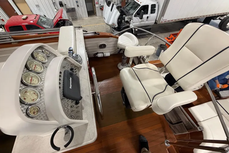 Slide: The Image of 1986 Skiff Craft X-31 Sportsman Custom boat interior with gauges and white seating. - 19