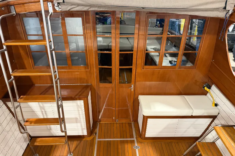 Slide: The Image of Interior of 1986 Skiff Craft X-31 Sportsman Custom with wooden finish and seating area. - 2