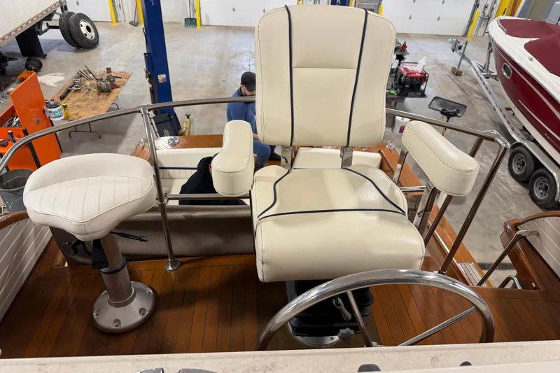 Slide: The Image of 1986 Skiff Craft X-31 Sportsman Custom boat interior with white captain's chair and steering wheel. - 20
