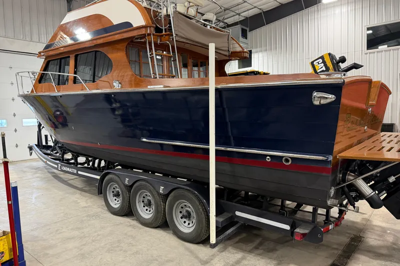 Slide: The Image of 1986 Skiff Craft X-31 Sportsman Custom boat on trailer in indoor storage facility. - 23