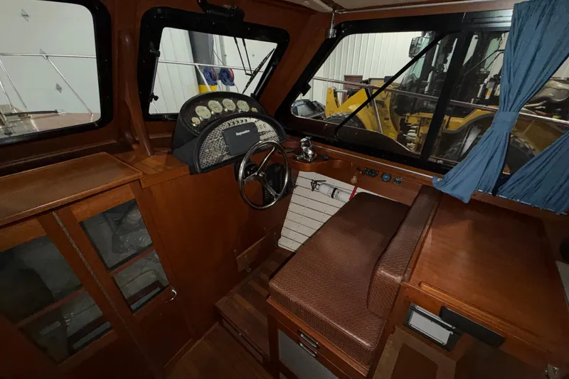 Slide: The Image of 1986 Skiff Craft X-31 Sportsman Custom boat interior with wooden dashboard and steering wheel. - 25