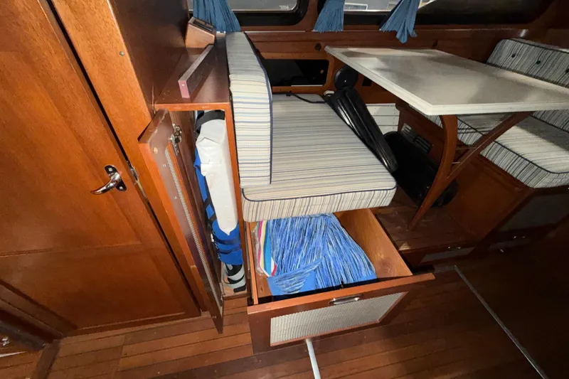 Slide: The Image of Interior of 1986 Skiff Craft X-31 Sportsman Custom with wooden cabinetry and striped seating. - 27