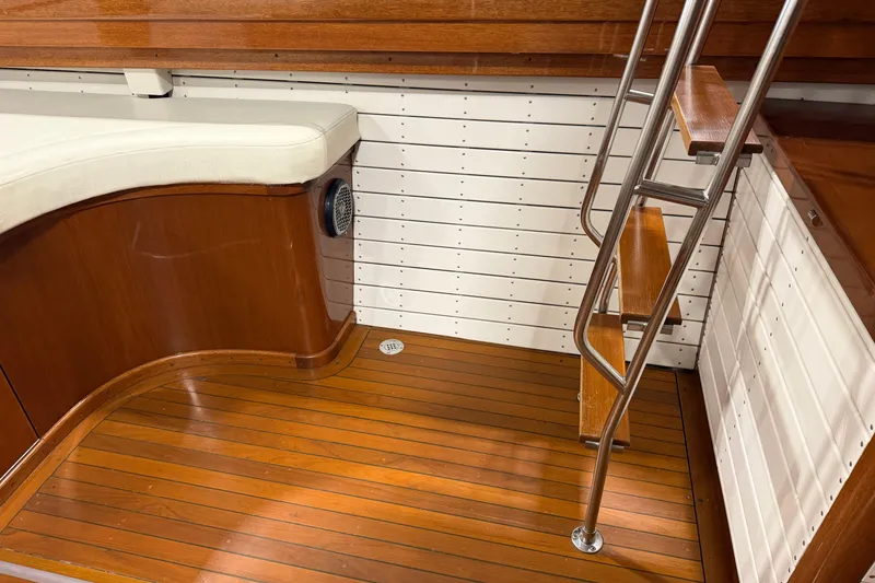Slide: The Image of 1986 Skiff Craft X-31 Sportsman Custom interior with wooden flooring and ladder. - 3