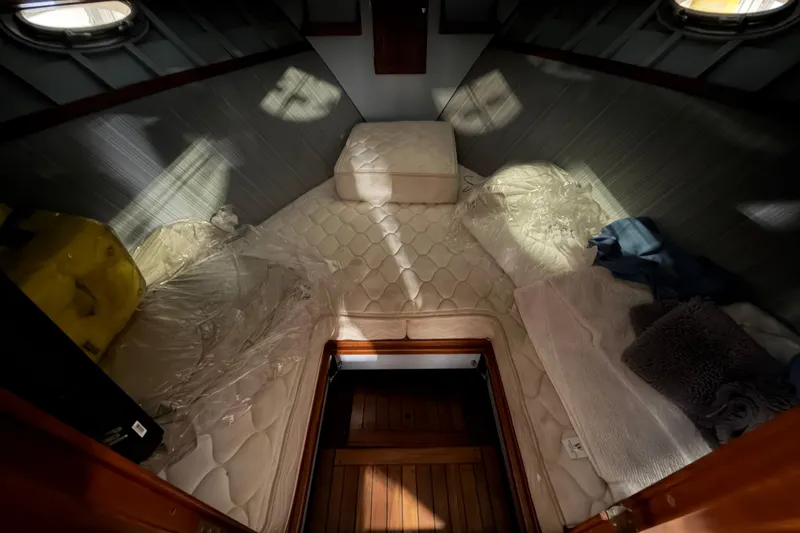 Slide: The Image of Interior cabin of 1986 Skiff Craft X-31 Sportsman Custom with cozy bedding and wooden flooring. - 30