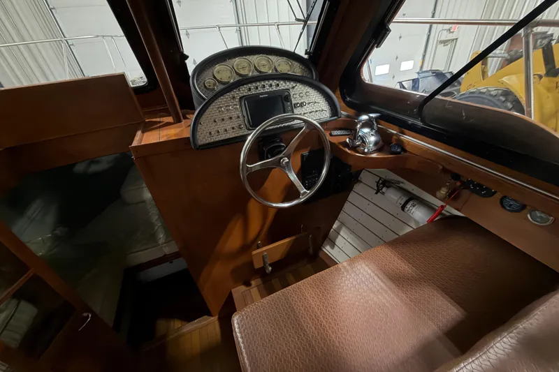 Slide: The Image of 1986 Skiff Craft X-31 Sportsman Custom boat interior with steering wheel and dashboard controls. - 31