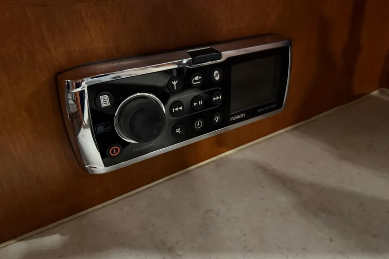 Slide: The Image of Control panel on 1986 Skiff Craft X-31 Sportsman Custom boat, featuring Fusion audio system. - 33