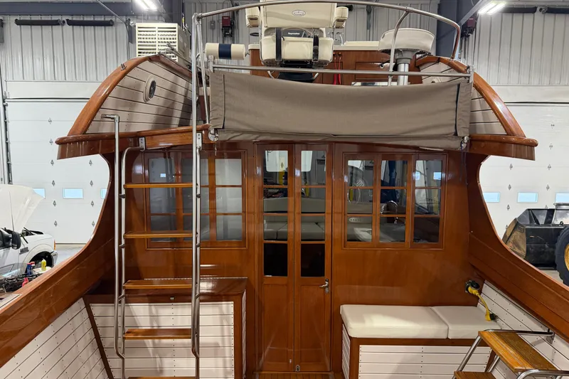 Slide: The Image of 1986 Skiff Craft X-31 Sportsman Custom boat interior with wooden finish and seating area. - 6