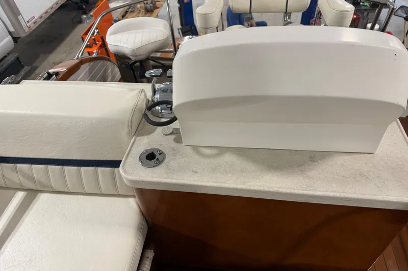 Slide: The Image of 1986 Skiff Craft X-31 Sportsman Custom boat interior with white seating and control panel. - 8