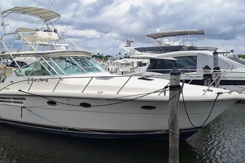 The Image of 1998 Tiara Yachts 4100 Open docked at marina under cloudy sky. - 0