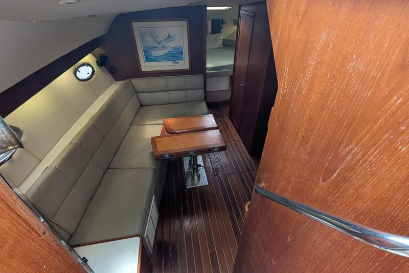 Slide: The Image of Interior of 1998 Tiara Yachts 4100 Open with wood flooring and cozy seating area. - 13
