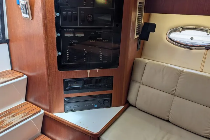 Slide: The Image of Interior of 1998 Tiara Yachts 4100 Open, featuring control panel and beige seating. - 17