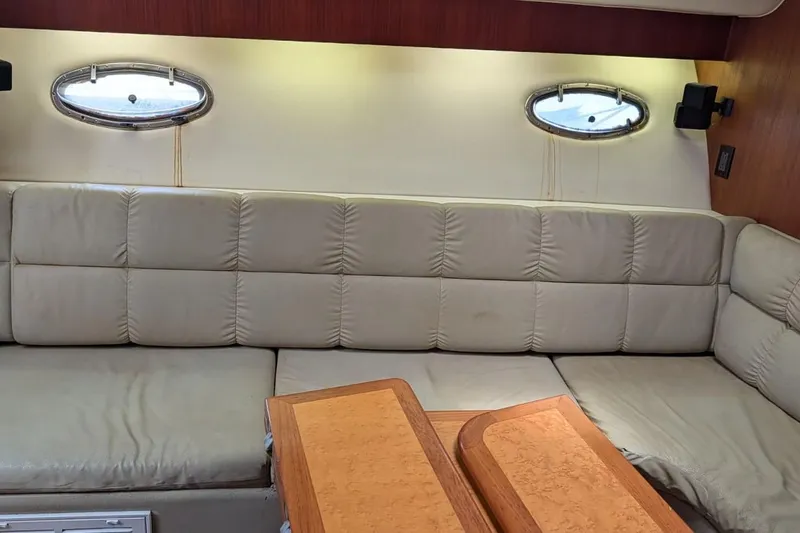 Slide: The Image of Interior of 1998 Tiara Yachts 4100 Open with beige seating and wooden table. - 18