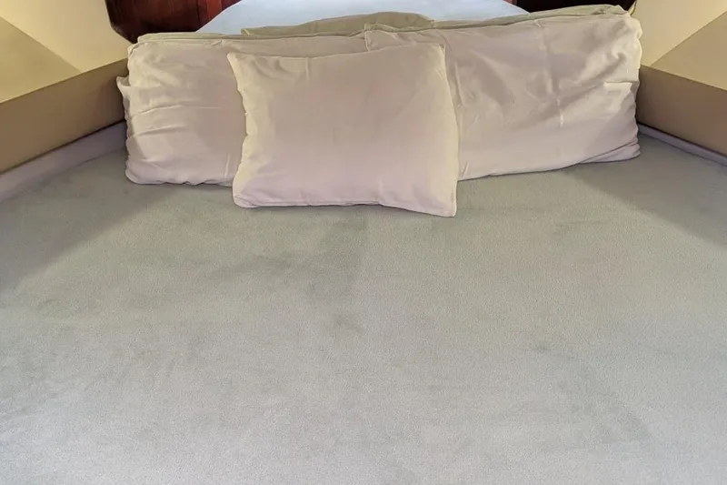 Slide: The Image of Interior cabin bed of 1998 Tiara Yachts 4100 Open with white pillows. - 20
